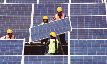 Workers install solar panels. Kazakhstan has launched the production of solar panels near Astana as part of its industrialization drive. 1358989848