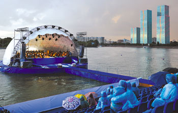 Despite bad weather conditions, residents and guests of the capital came to the Yessil River bank to enjoy the classical music. 1373471103